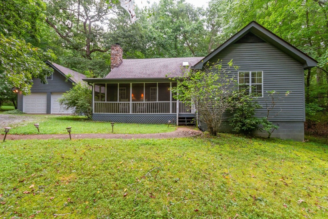 161 Curlicue Road Sewanee, TN 37375 - Photo 48 of 50 a front view of a house with a yard and garage