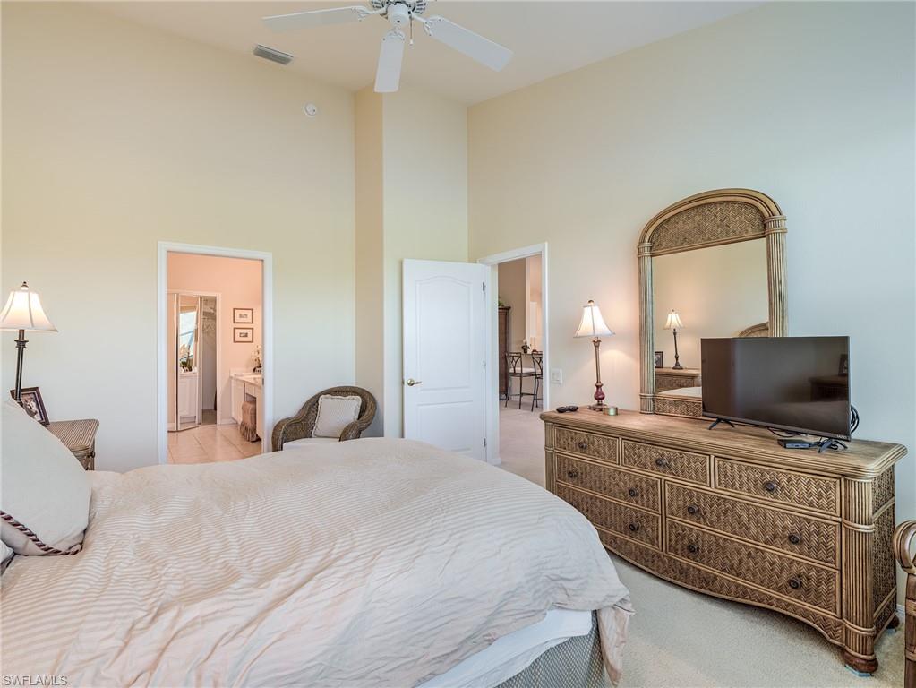9830 Spring Run Boulevard, Unit 3408 Estero, FL 34135 - Photo 15 of 24 a bedroom with a bed and a flat screen tv
