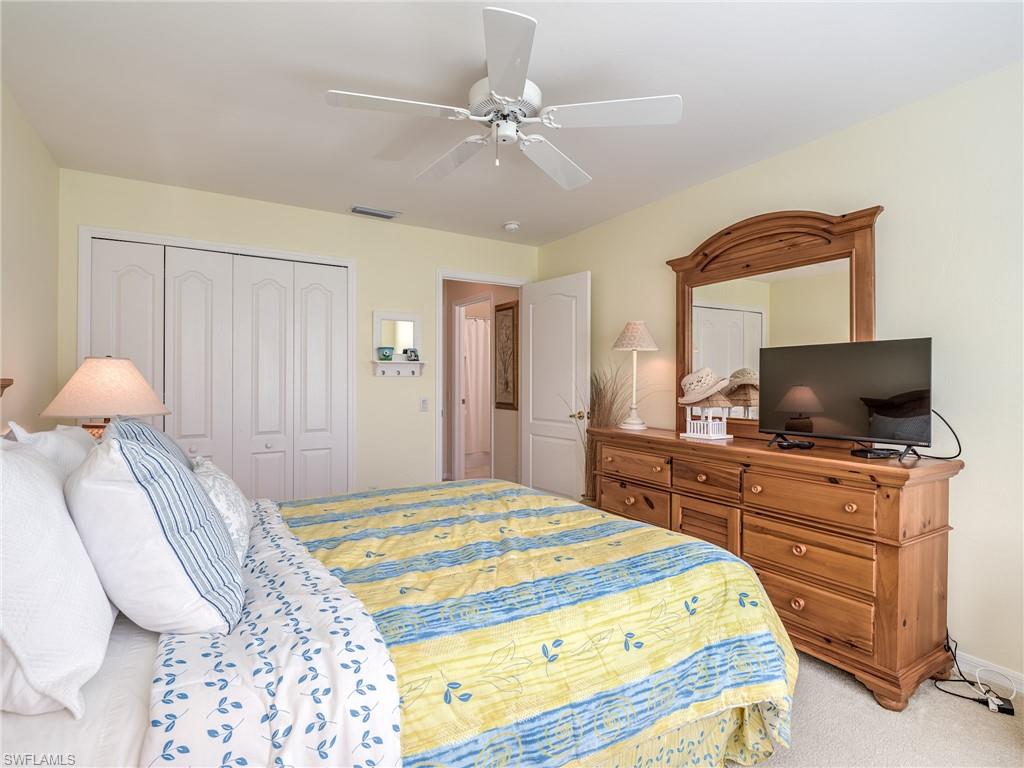 9830 Spring Run Boulevard, Unit 3408 Estero, FL 34135 - Photo 20 of 24 a bedroom with a bed and a flat screen tv