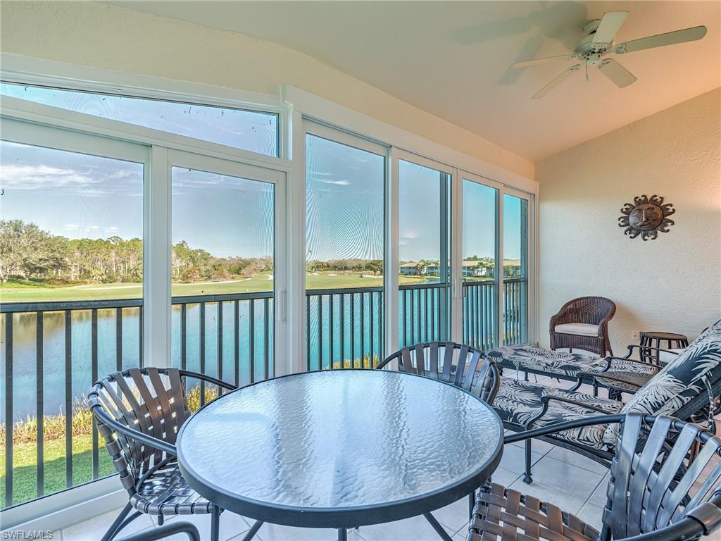 9830 Spring Run Boulevard, Unit 3408 Estero, FL 34135 - Photo 2 of 24 a balcony with table and chairs