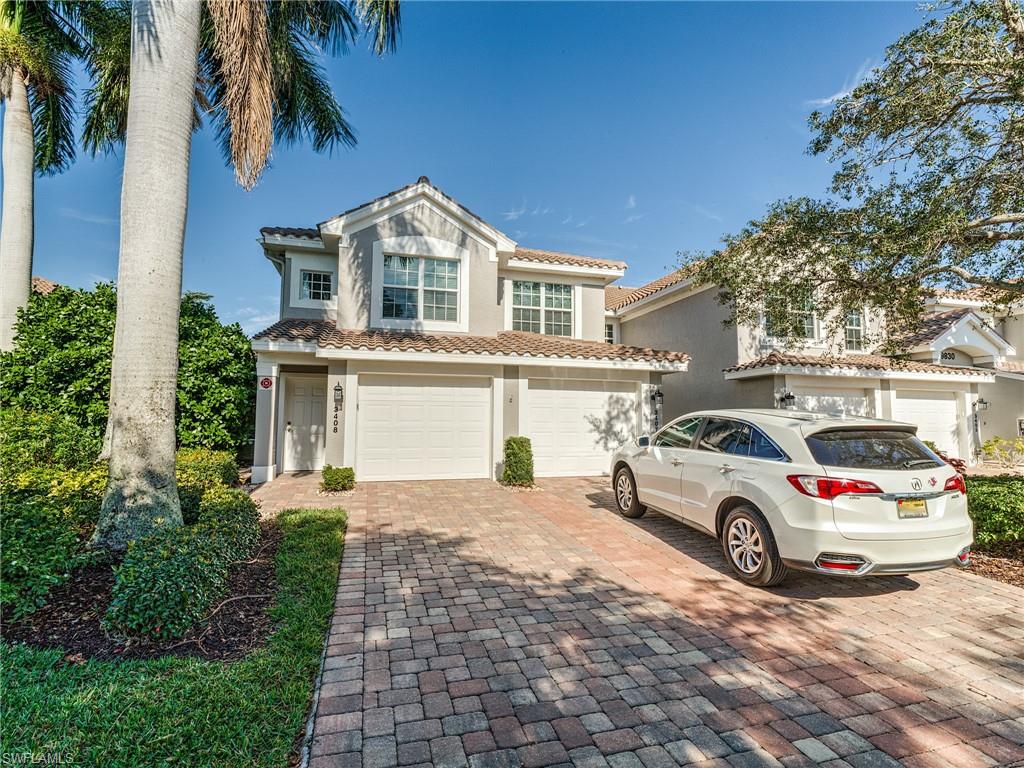 9830 Spring Run Boulevard, Unit 3408 Estero, FL 34135 - Photo 23 of 24 a car parked in front of white house