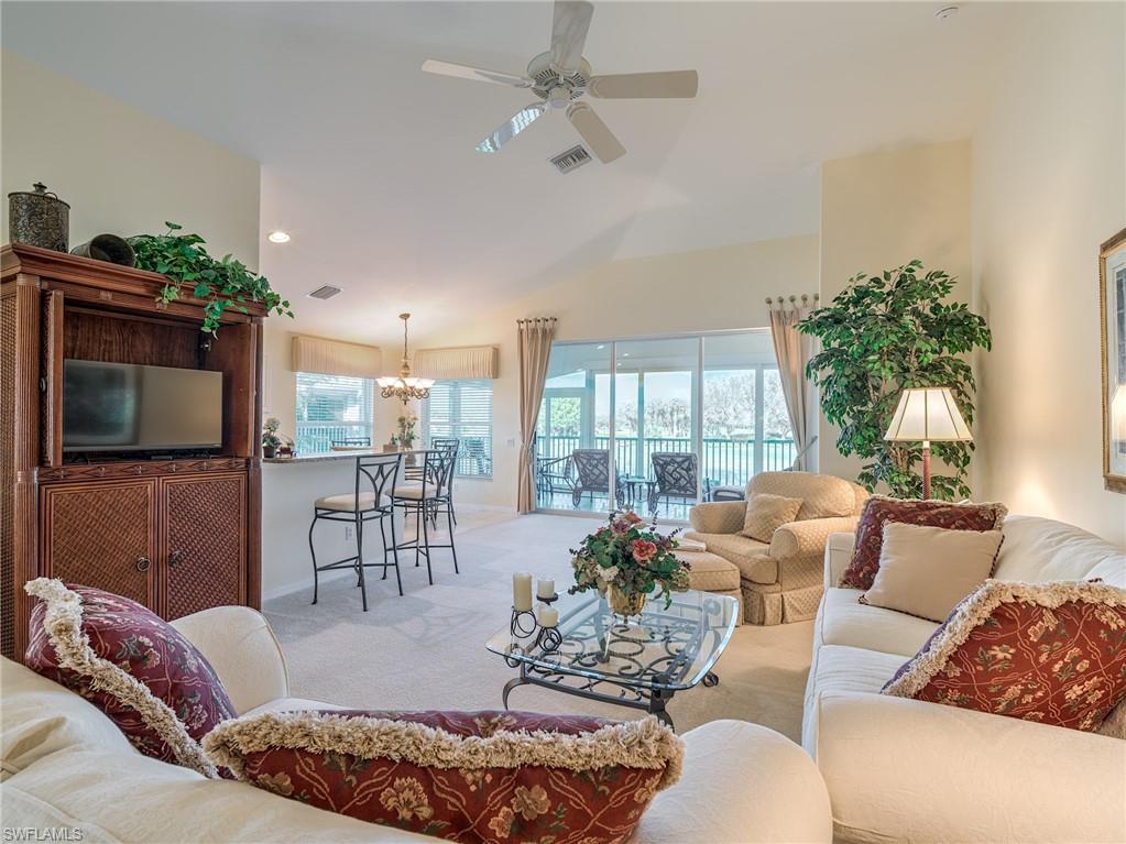 9830 Spring Run Boulevard, Unit 3408 Estero, FL 34135 - Photo 3 of 24 a living room with furniture and a flat screen tv