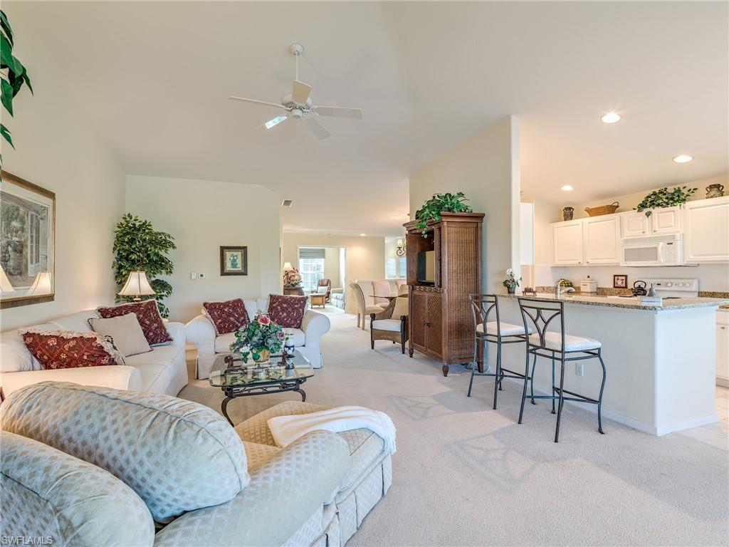 9830 Spring Run Boulevard, Unit 3408 Estero, FL 34135 - Photo 5 of 24 a living room with furniture and a view of kitchen
