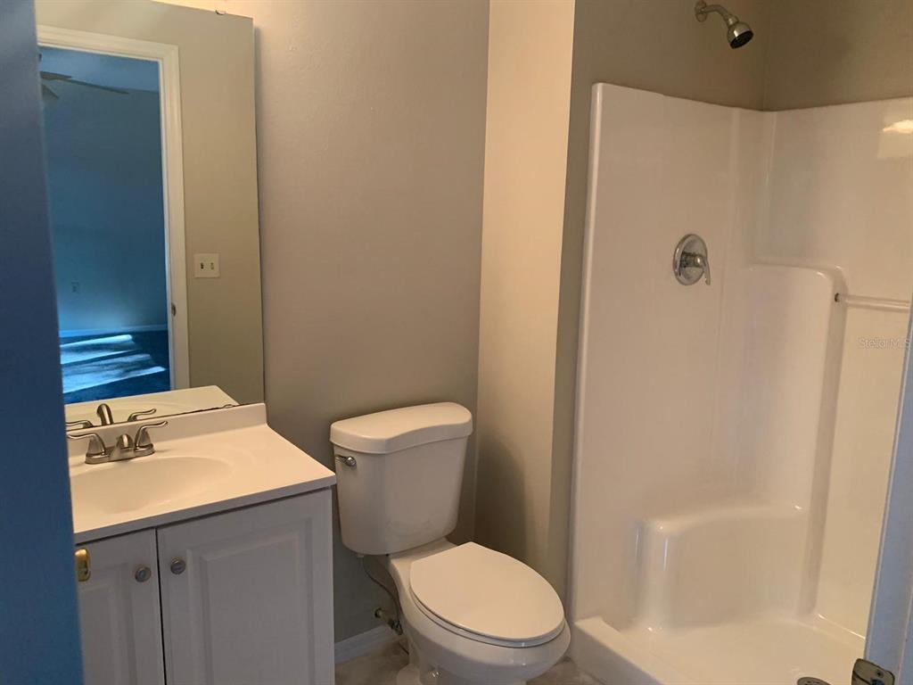 5127 Mill Stream Road Ocoee, FL 34761 - Photo 10 of 20 a white toilet sitting next to a bathroom sink