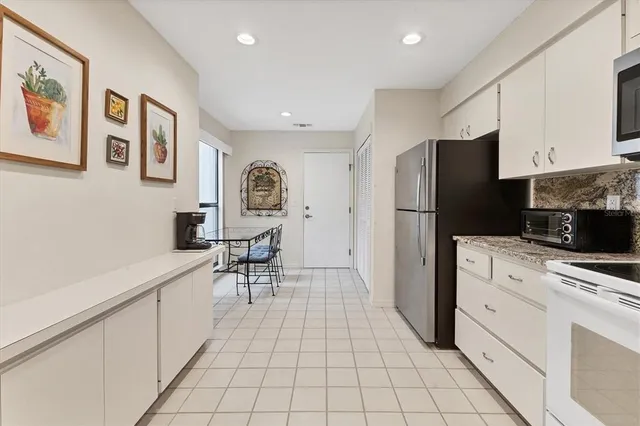 a kitchen with stainless steel appliances a refrigerator sink and cabinets
