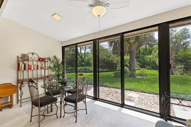 a living room with furniture and a floor to ceiling window