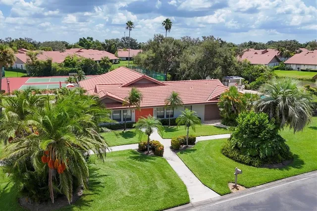 a view of a house with a yard and potted plants