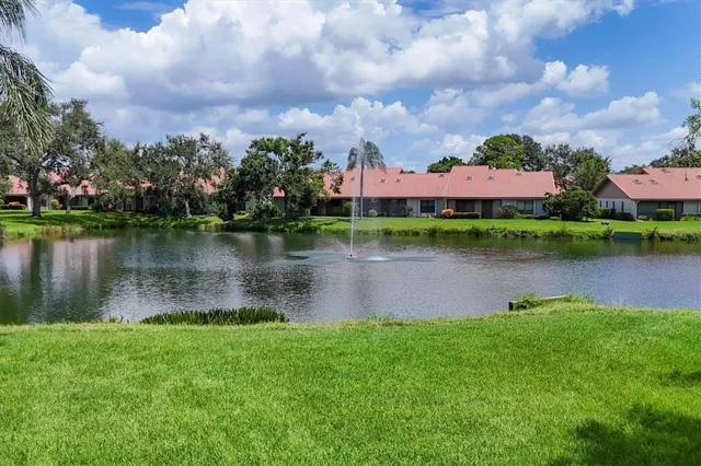 a lake view with a garden and houses