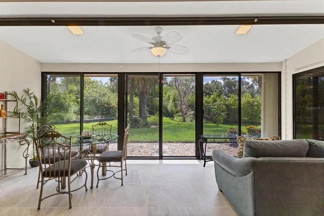 a living room with furniture and large windows