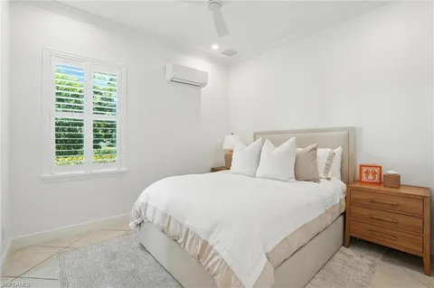 a bedroom with bed and window