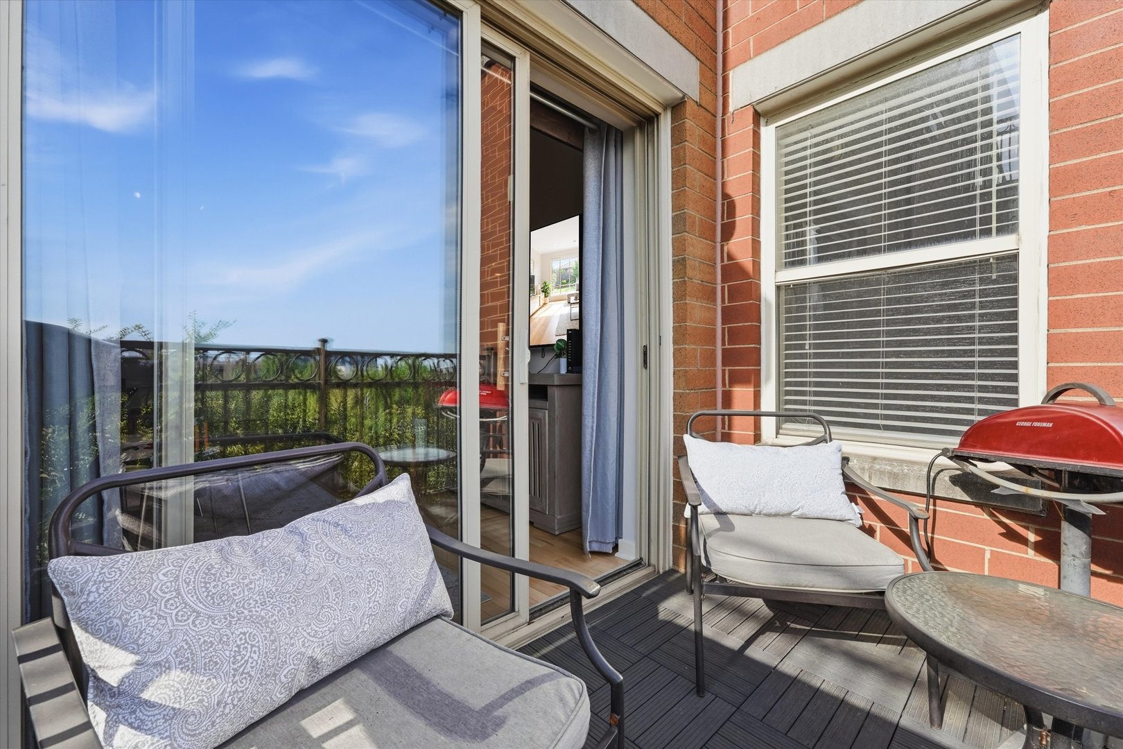 1155 West Roosevelt Road, Unit 404 Chicago, IL 60608 - Photo 22 of 30 a view of a patio with couches chairs dining table and chairs
