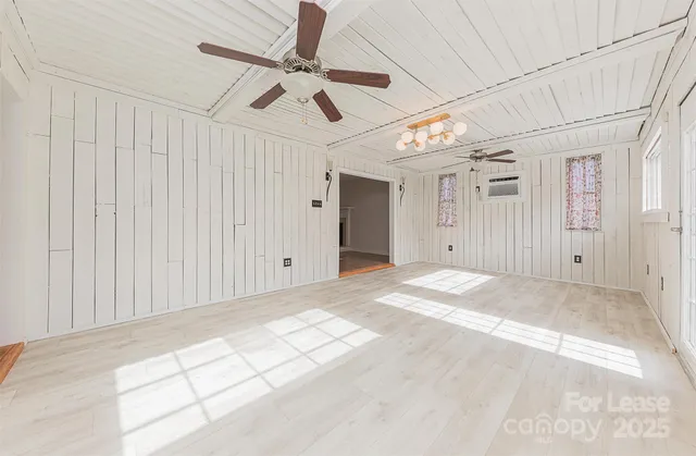 a view of a livingroom with a ceiling fan and window