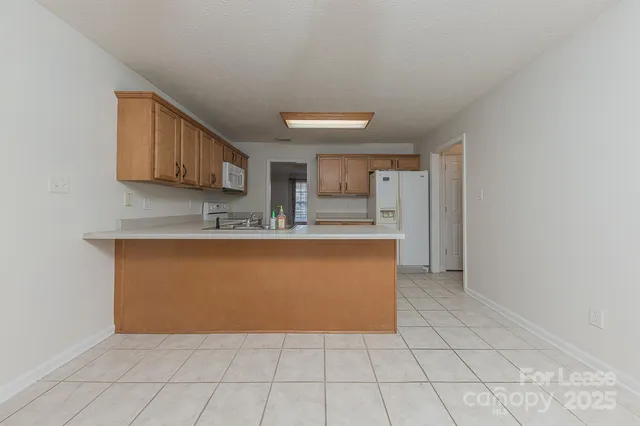 a view of kitchen with granite countertop cabinets and a sink