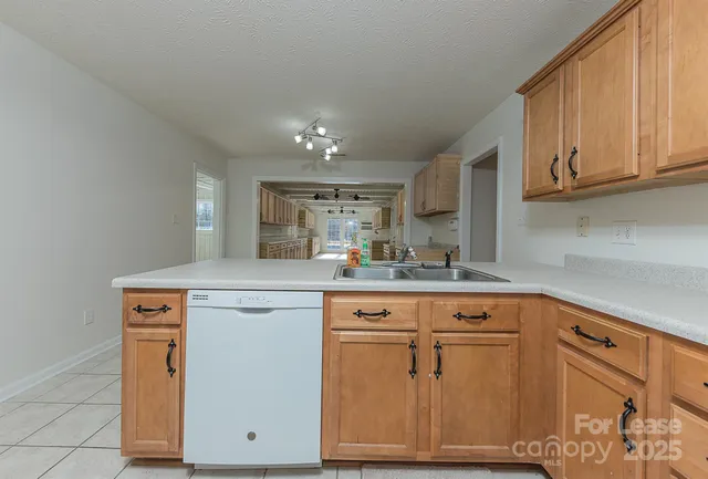 a kitchen with cabinets appliances and a counter space