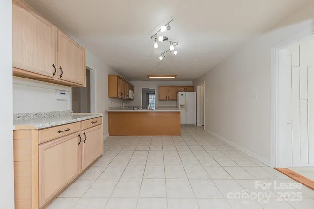 a large kitchen with cabinets and stainless steel appliances