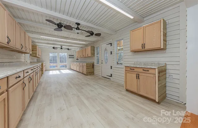 a kitchen with stove cabinets and wooden floor