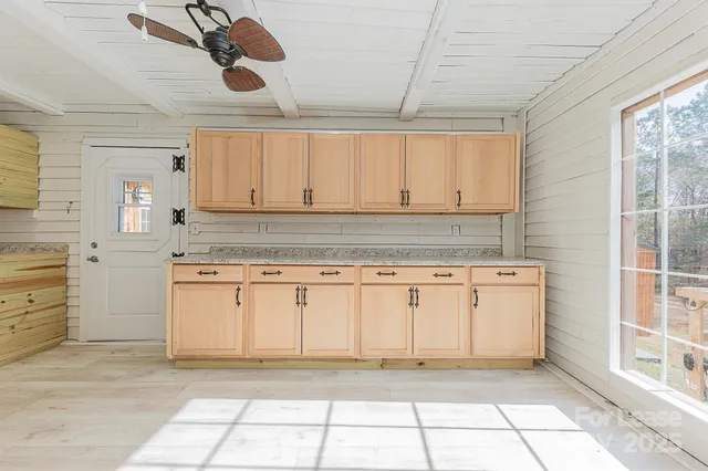 a kitchen with a stove a sink and cabinets