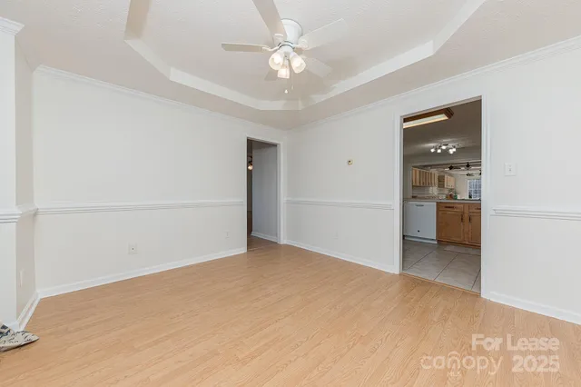 a view of an empty room with a ceiling fan