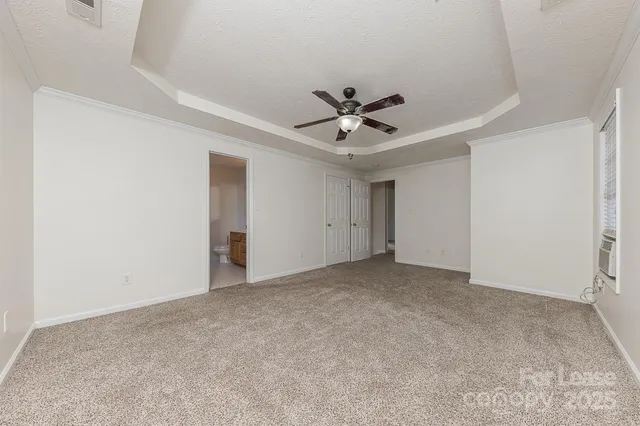 a view of an empty room with a ceiling fan