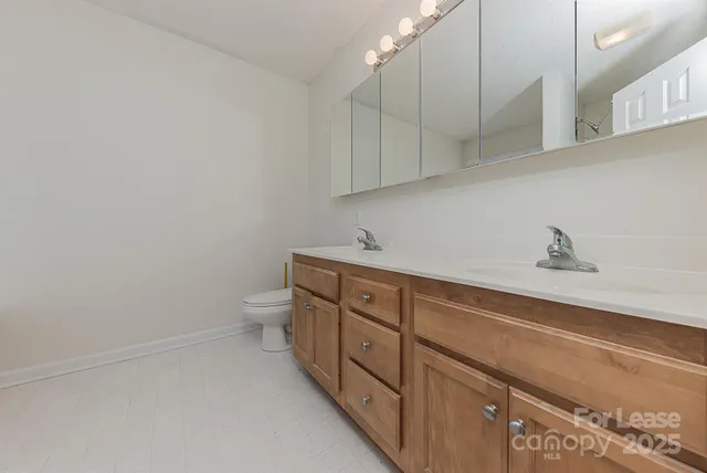 a spacious bathroom with a toilet