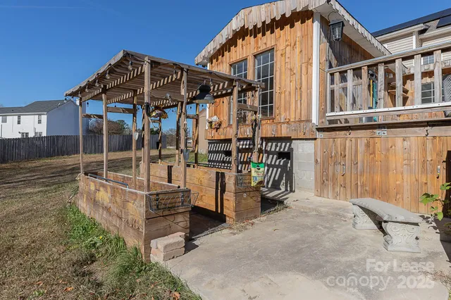 front view of a house with a wooden deck