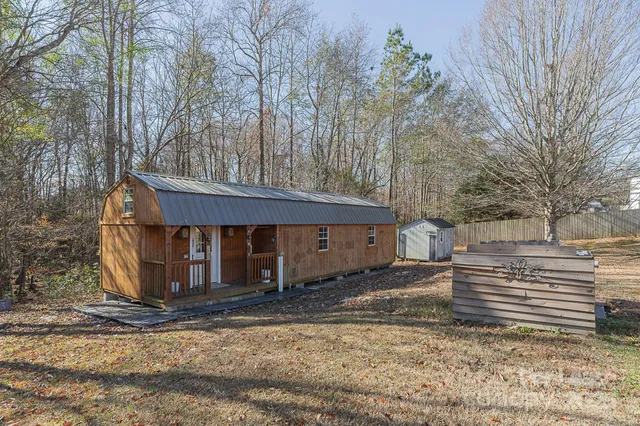 a view of a house with a yard covered in snow