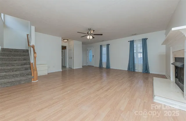 wooden floor in an empty room with a fireplace