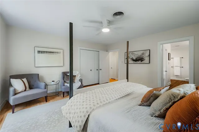 a bedroom with a bed couch and window