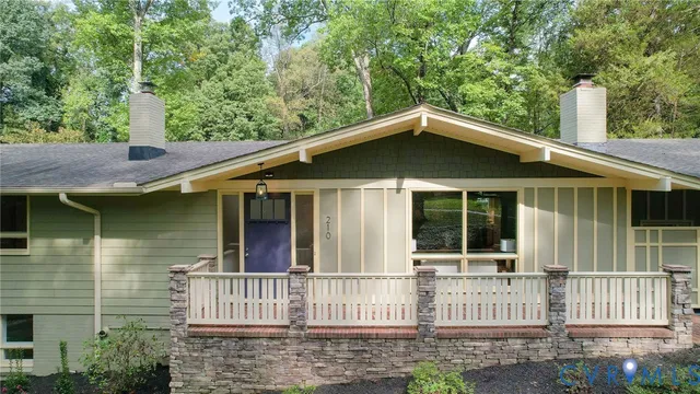a brick house with large windows and a small yard