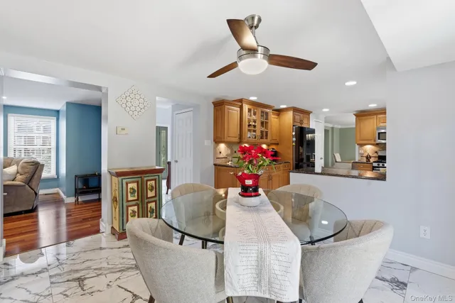 a view of a dining room with furniture and chandelier
