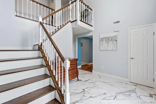 a view of staircase with white walls and a window