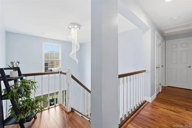 a view of a room with wooden floor and stairs