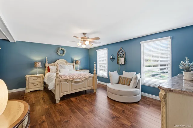 a bedroom with furniture and wooden floor