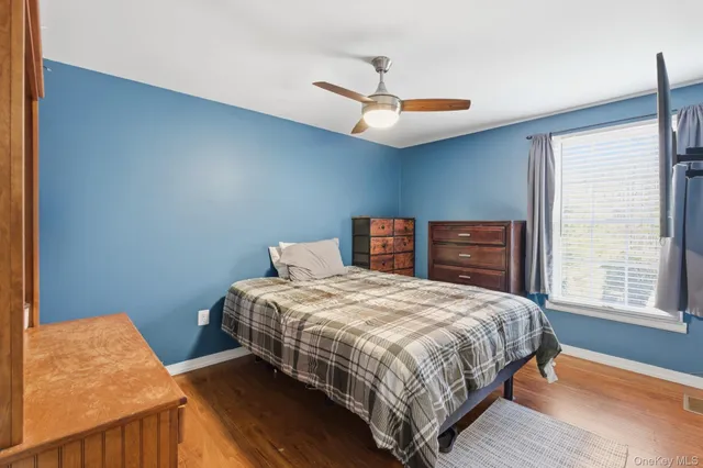 a bedroom with a bed a window and a chandelier