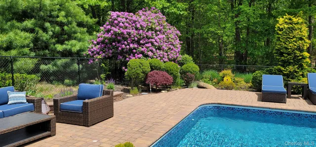 a view of a patio with couches table and chairs and potted plants