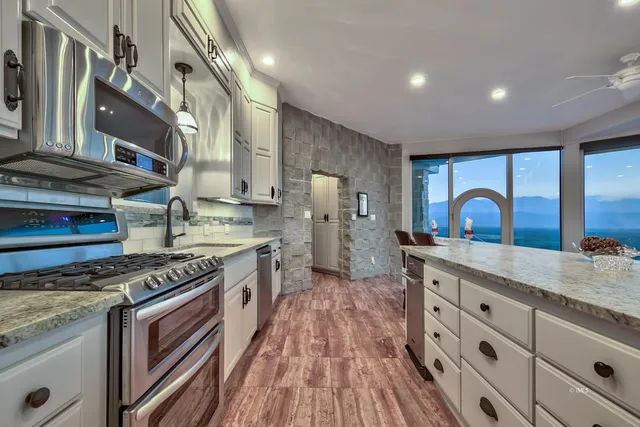 a kitchen with granite countertop a stove and a sink