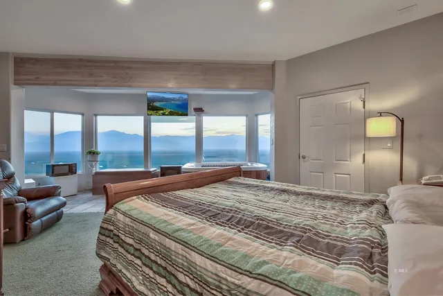 a bedroom with a large bed and a large window