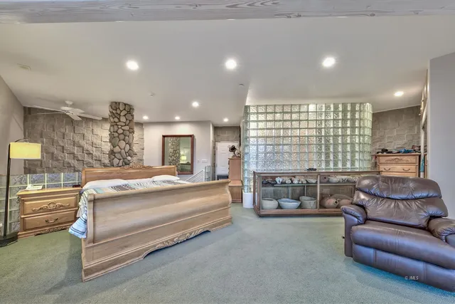 a bed room with furniture and a large window