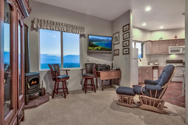 a kitchen with stainless steel appliances a table chairs in it and a window