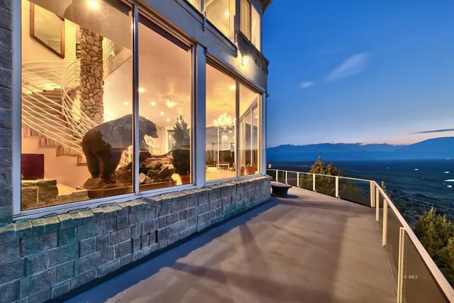 a view of a balcony with mountain view and wooden floor