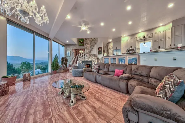 a living room with furniture wooden floor and a large window
