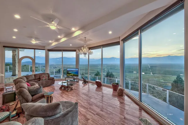 a living room with furniture and a floor to ceiling window
