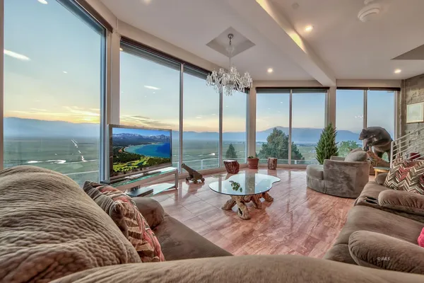 a living room with furniture and floor to ceiling window