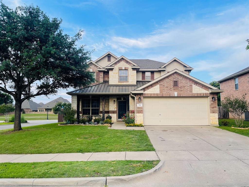 516 Angela Lane Euless, TX 76039 - Photo 30 of 39 View of front of home featuring covered porch, driveway, an attached garage, a front lawn, and a standing seam roof