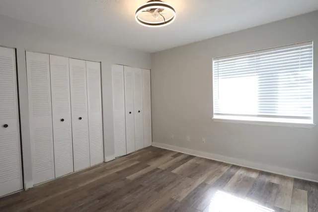 a view of a room with wooden floor and window