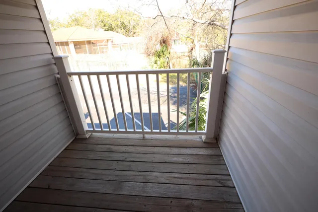 a view of balcony with wooden floor