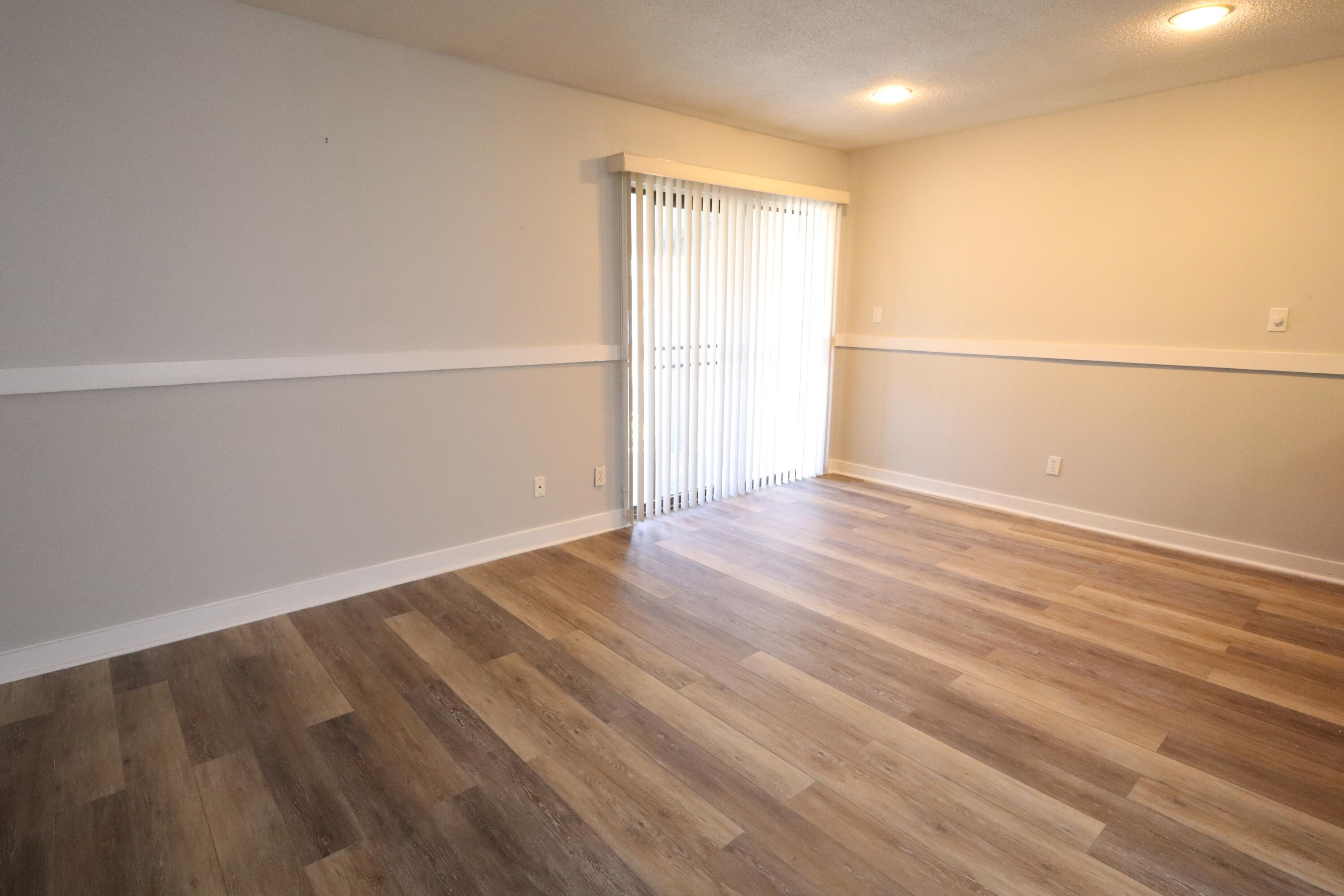101 Old Ferry Road, Unit 36D Shalimar, FL 32579 - Photo 5 of 17 an empty room with wooden floor and windows