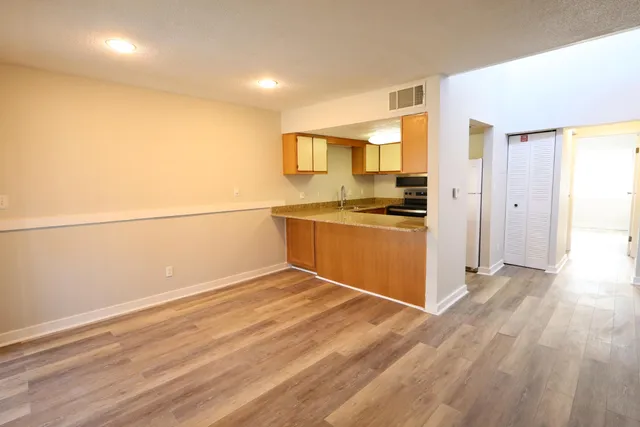a view of a kitchen with a sink and a stove top oven