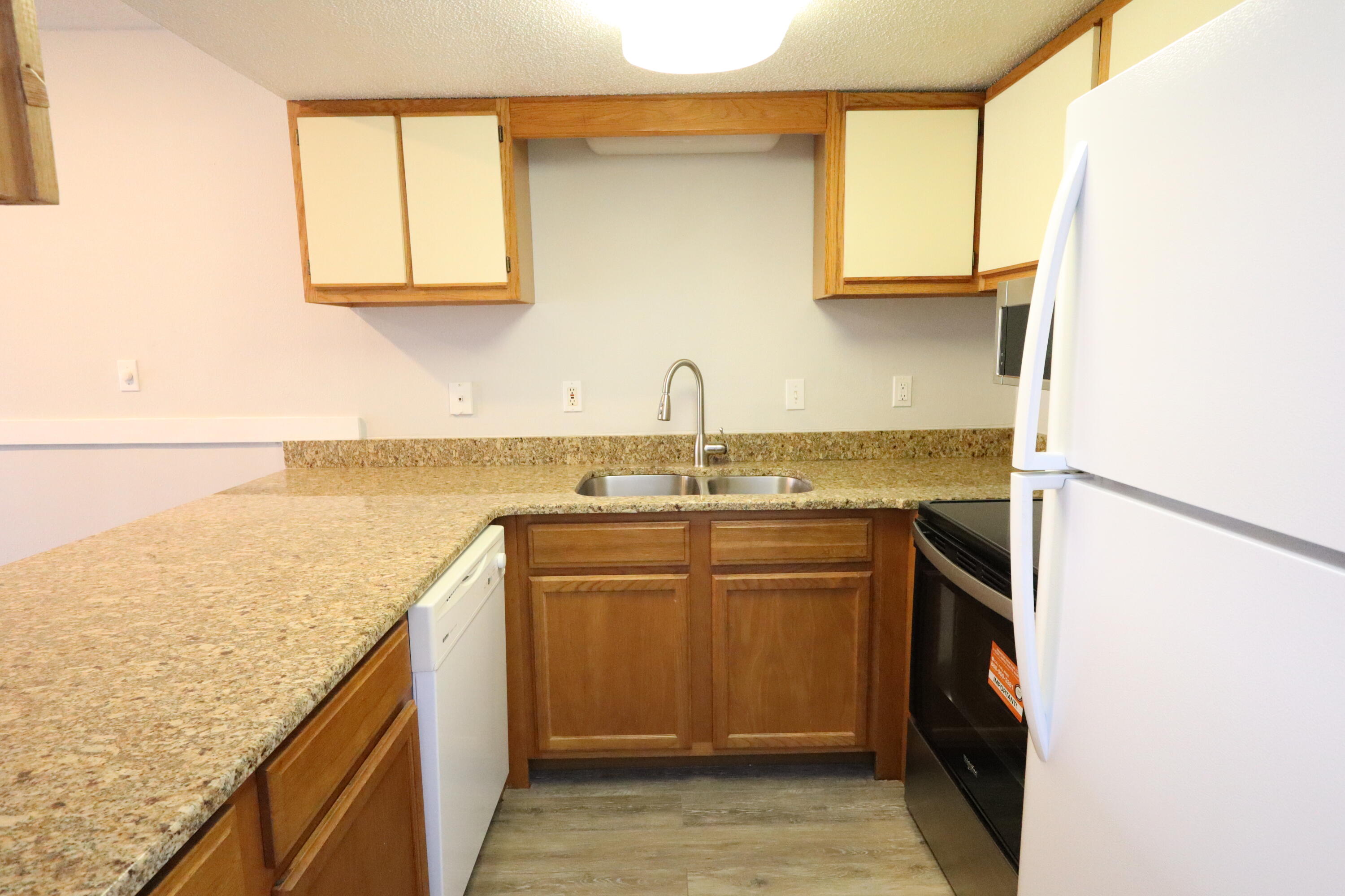 101 Old Ferry Road, Unit 36D Shalimar, FL 32579 - Photo 8 of 17 a kitchen with stainless steel appliances granite countertop a sink and a stove