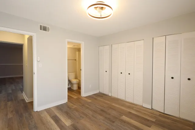 a view of a room with wooden floor and closet
